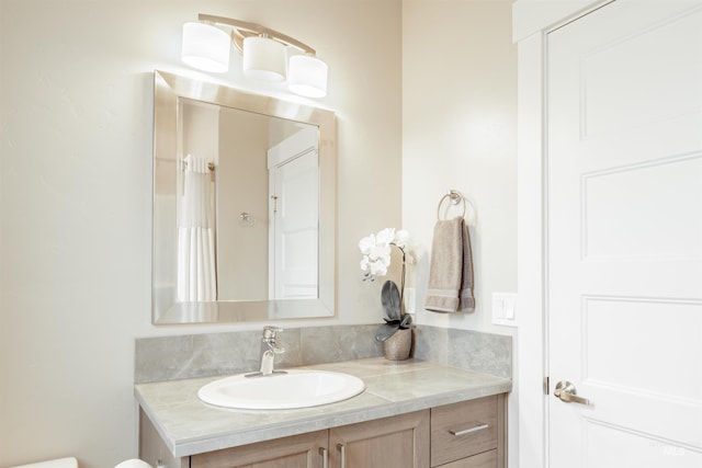 bathroom featuring toilet and vanity