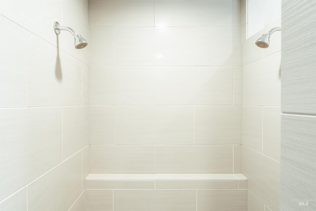 bathroom with tiled shower