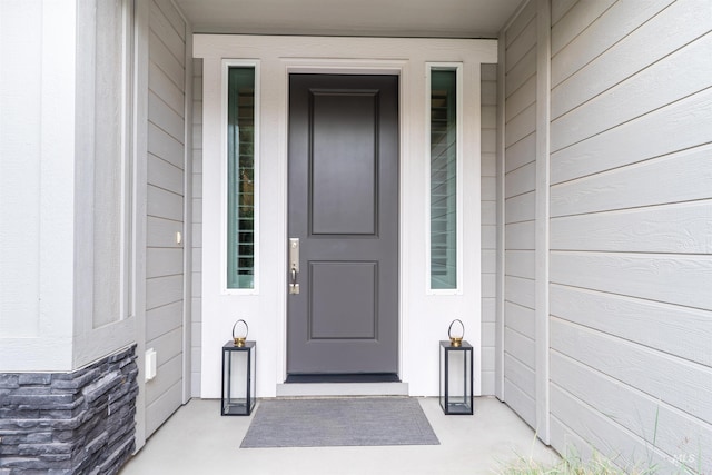doorway to property with stone siding