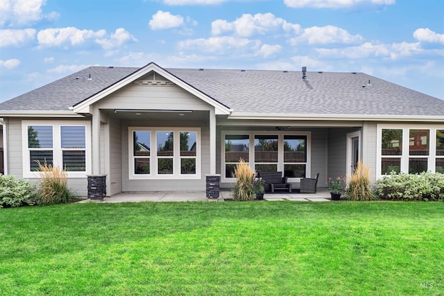 back of property featuring an outdoor living space, a yard, a patio area, and roof with shingles