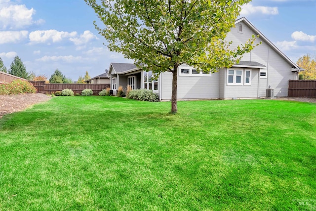 view of yard with cooling unit and fence