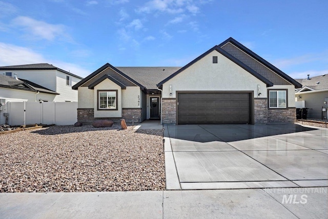 single story home featuring concrete driveway, stone siding, and stucco siding