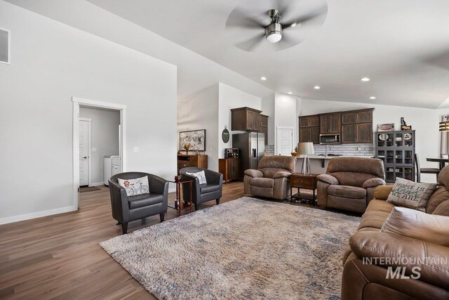 laundry room with independent washer and dryer, light hardwood / wood-style flooring, and cabinets