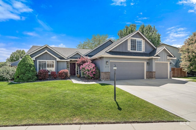 613 E Sable Ridge Dr, Kuna, ID 83634 - view of front of property with a garage, concrete driveway, a shingled roof, and board and batten siding
