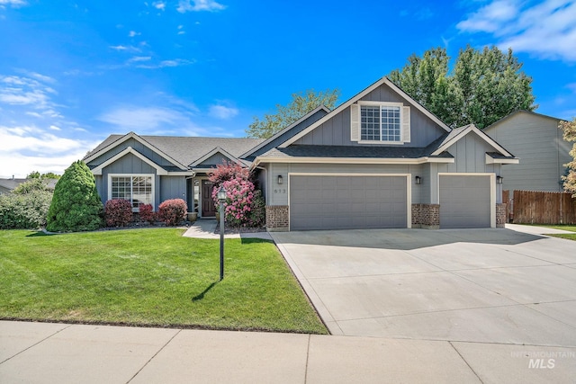 613 E Sable Ridge Dr, Kuna, ID 83634 - view of front facade featuring brick siding, board and batten siding, driveway, an attached garage, and a garage