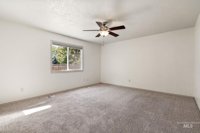613 E Sable Ridge Dr, Kuna, ID 83634 - empty room featuring ceiling fan, carpet flooring, a textured ceiling, and baseboards