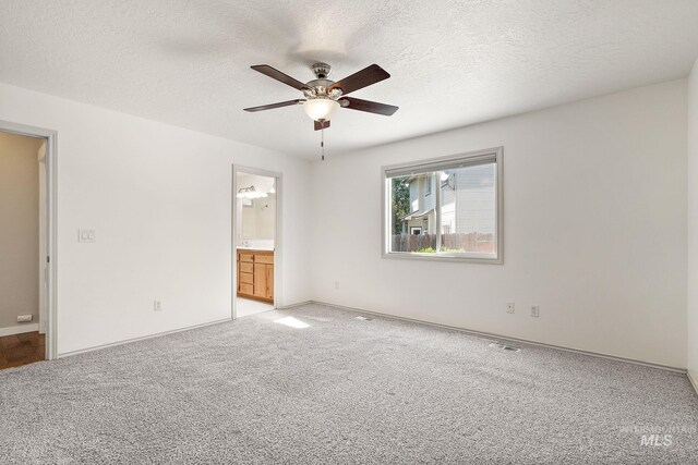 613 E Sable Ridge Dr, Kuna, ID 83634 - spare room featuring a ceiling fan, light colored carpet, baseboards, and a textured ceiling