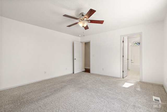 613 E Sable Ridge Dr, Kuna, ID 83634 - unfurnished bedroom featuring light colored carpet, ensuite bath, baseboards, and a ceiling fan