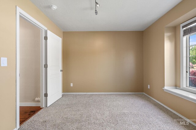 613 E Sable Ridge Dr, Kuna, ID 83634 - carpeted spare room with baseboards, a smoke detector, and rail lighting
