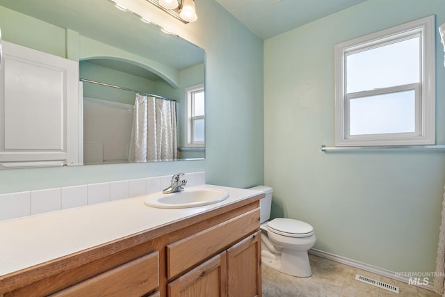 613 E Sable Ridge Dr, Kuna, ID 83634 - bathroom featuring vanity, toilet, baseboards, tile patterned floors, and a shower with shower curtain