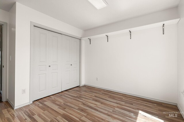 613 E Sable Ridge Dr, Kuna, ID 83634 - unfurnished bedroom with light wood-style flooring and a closet