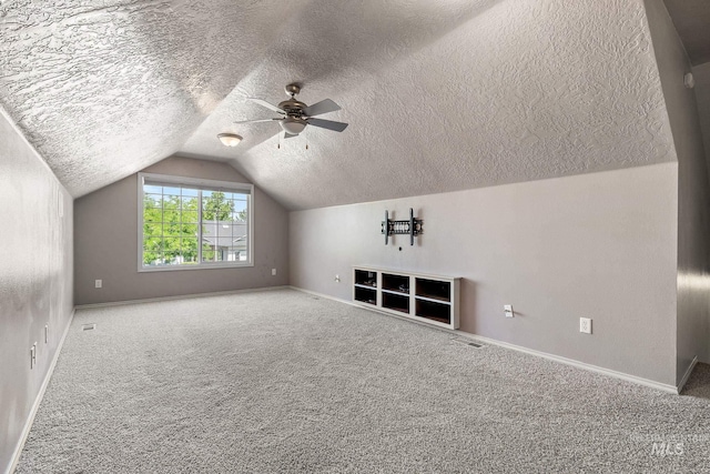 613 E Sable Ridge Dr, Kuna, ID 83634 - additional living space with baseboards, lofted ceiling, a textured ceiling, carpet, and ceiling fan