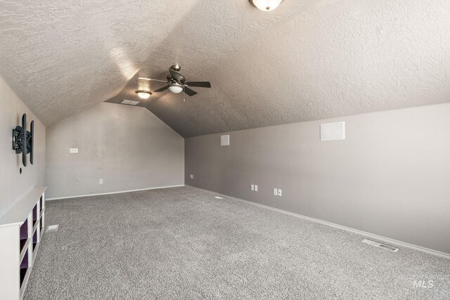 613 E Sable Ridge Dr, Kuna, ID 83634 - bonus room featuring a textured ceiling, ceiling fan, carpet flooring, lofted ceiling, and baseboards