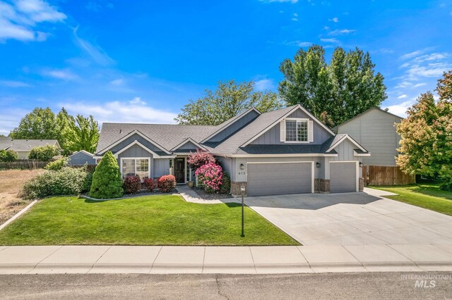 613 E Sable Ridge Dr, Kuna, ID 83634 - craftsman-style house with concrete driveway, board and batten siding, a garage, a shingled roof, and brick siding