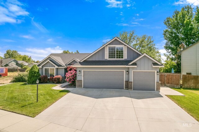 613 E Sable Ridge Dr, Kuna, ID 83634 - craftsman house with board and batten siding, concrete driveway, a garage, brick siding, and a shingled roof