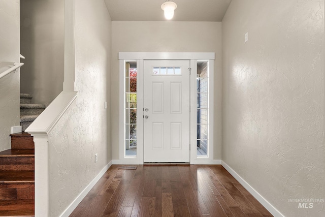 613 E Sable Ridge Dr, Kuna, ID 83634 - entrance foyer featuring hardwood / wood-style flooring, a textured wall, stairway, and baseboards