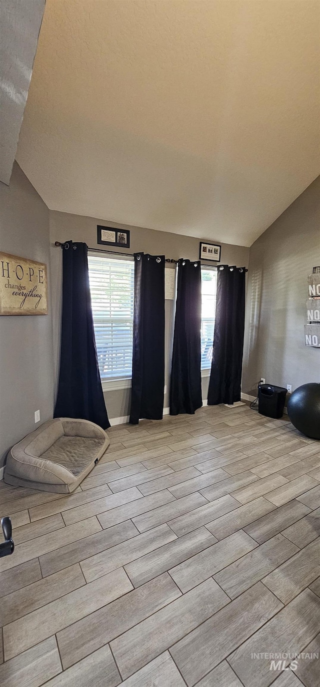 1122 N Roper Pl, Meridian, ID 83642 - unfurnished bedroom with light wood finished floors, baseboards, and lofted ceiling