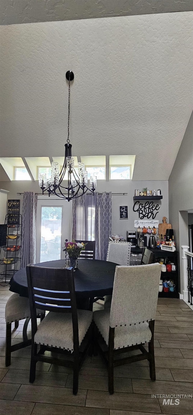 1122 N Roper Pl, Meridian, ID 83642 - dining area with a chandelier, wood finished floors, and a textured ceiling