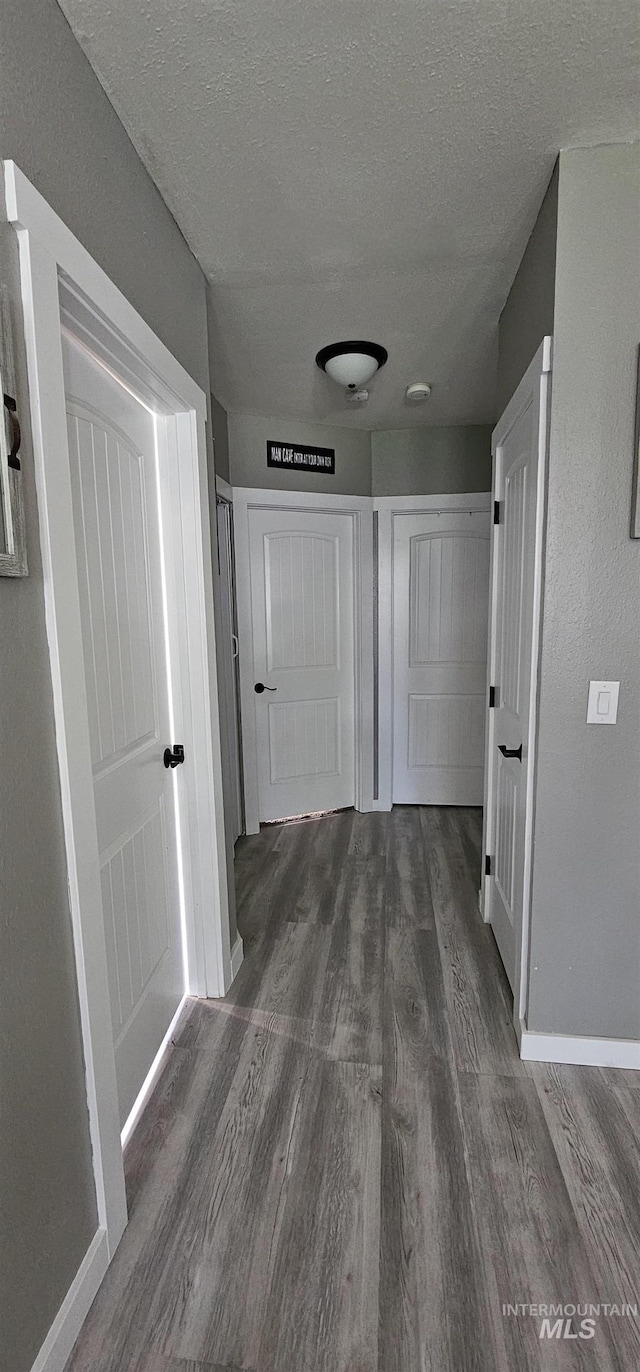 1122 N Roper Pl, Meridian, ID 83642 - hall featuring dark wood-style flooring, a textured ceiling, and baseboards