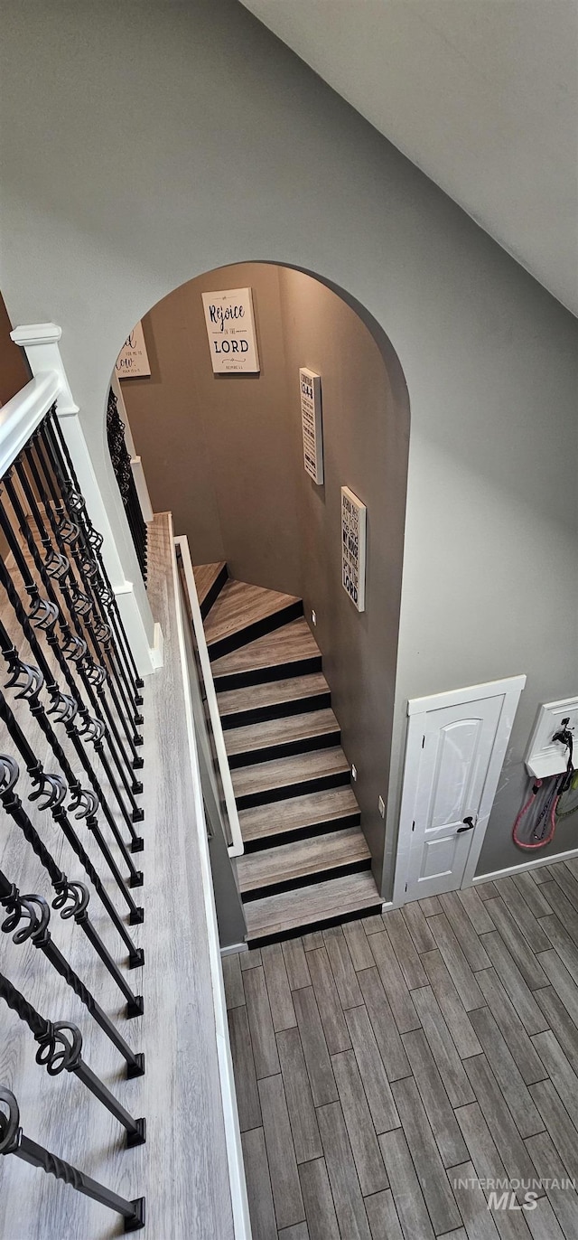 1122 N Roper Pl, Meridian, ID 83642 - staircase featuring wood finished floors and arched walkways