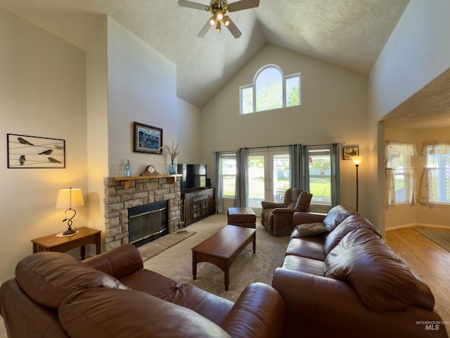 2361 N Pollard Ln, Star, ID 83669 - living area featuring ceiling fan, high vaulted ceiling, a textured ceiling, a fireplace, and wood finished floors