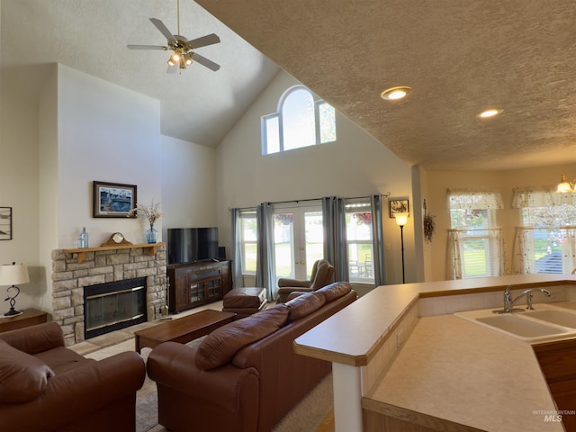 2361 N Pollard Ln, Star, ID 83669 - living room featuring a textured ceiling, ceiling fan, high vaulted ceiling, and a fireplace