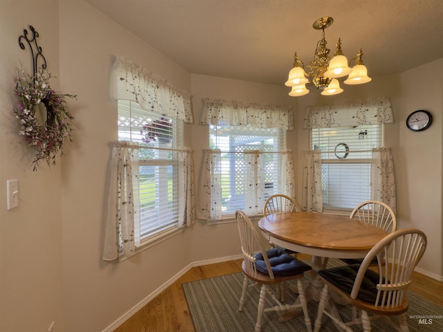 2361 N Pollard Ln, Star, ID 83669 - dining space with a chandelier, baseboards, and wood finished floors