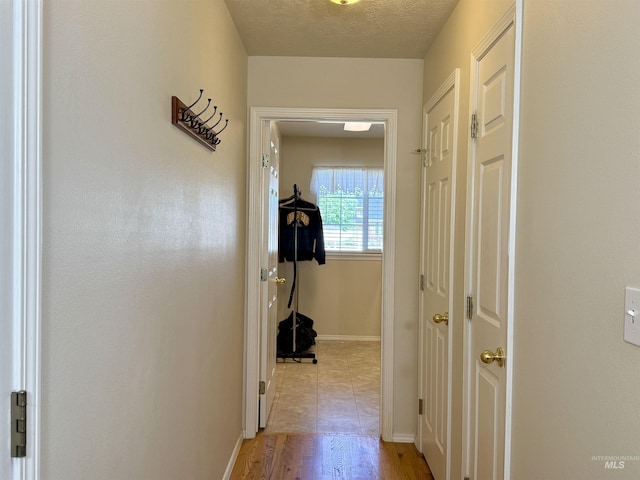 2361 N Pollard Ln, Star, ID 83669 - hall with baseboards, light wood-type flooring, and a textured ceiling