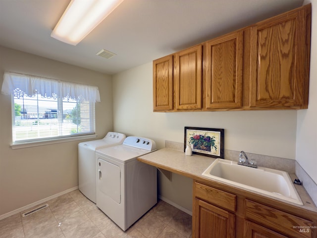 2361 N Pollard Ln, Star, ID 83669 - laundry room with independent washer and dryer, cabinet space, baseboards, and light tile patterned flooring