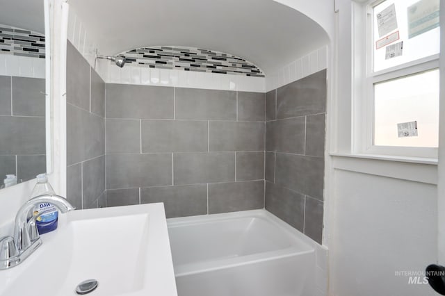 bathroom with a sink and shower / bath combination