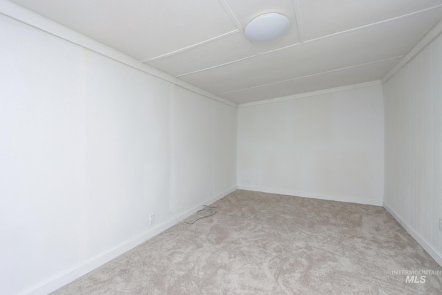 spare room featuring carpet floors and baseboards