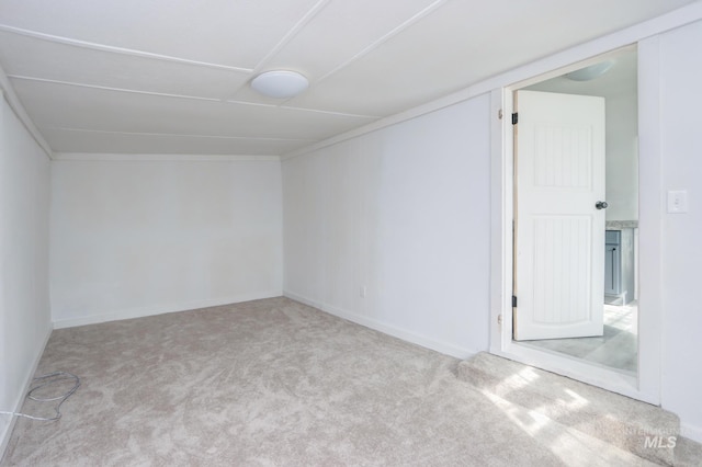 empty room featuring carpet and baseboards