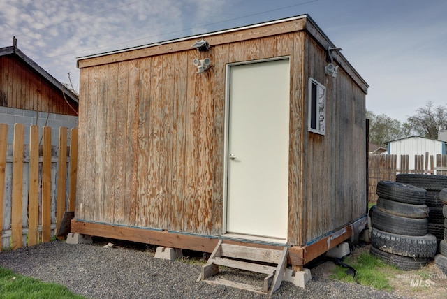 view of shed featuring fence