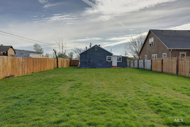 view of yard featuring entry steps and a fenced backyard