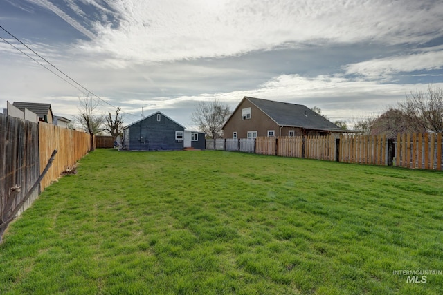 view of yard featuring a fenced backyard and an outdoor structure