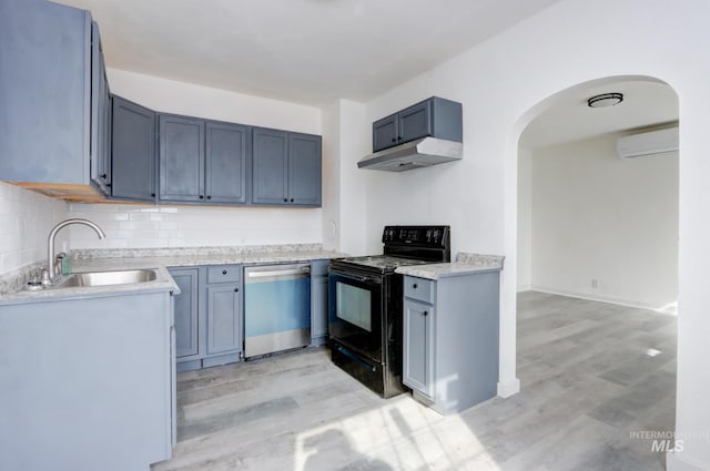 kitchen featuring arched walkways, a wall unit AC, dishwasher, a sink, and black range with electric cooktop