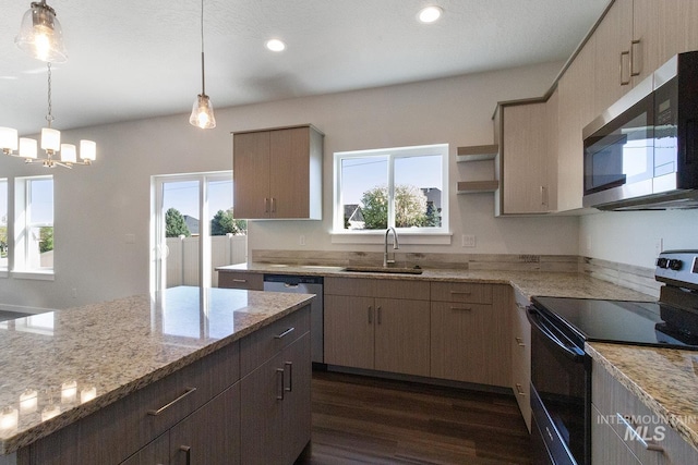kitchen with light stone counters, a sink, appliances with stainless steel finishes, dark wood-style flooring, and recessed lighting