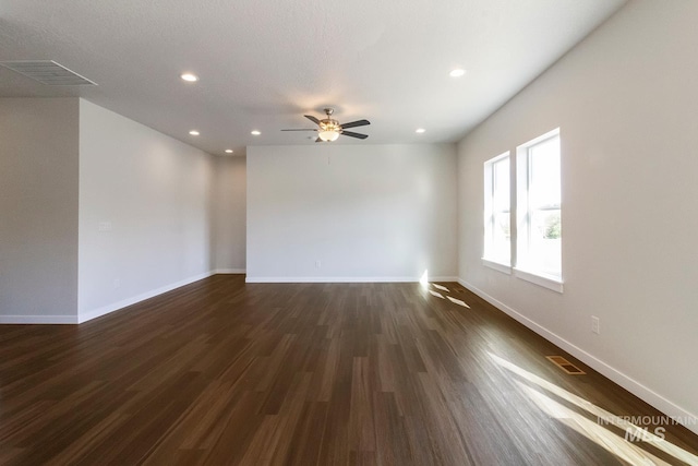 unfurnished room with recessed lighting, visible vents, a ceiling fan, dark wood-type flooring, and baseboards