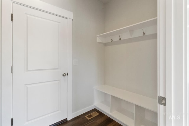 mudroom with baseboards, visible vents, and dark wood-style floors