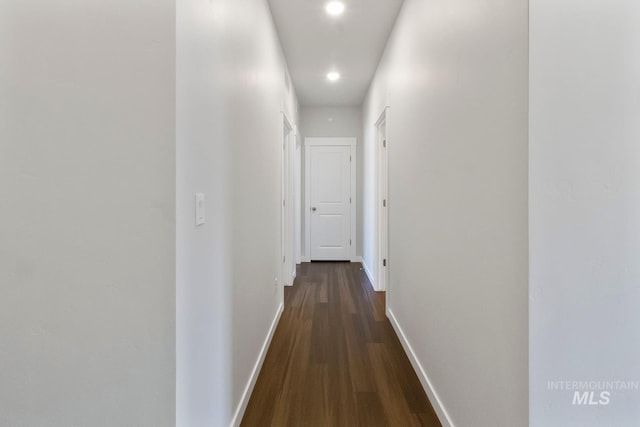 hallway with baseboards, dark wood-type flooring, and recessed lighting