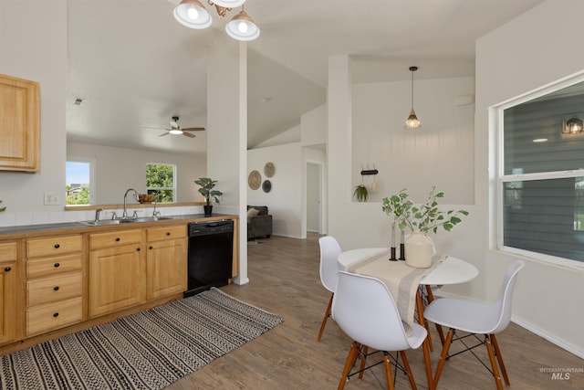 1045 S Arrowrock Ave, Middleton, ID 83644 - kitchen featuring black dishwasher, light brown cabinetry, wood finished floors, vaulted ceiling, and a ceiling fan