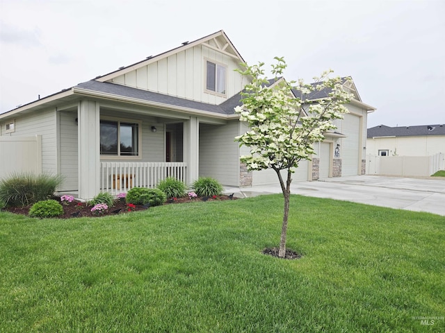2716 Dogwood Ave, Fruitland, ID 83619 - view of front of house featuring board and batten siding, driveway, a porch, and an attached garage