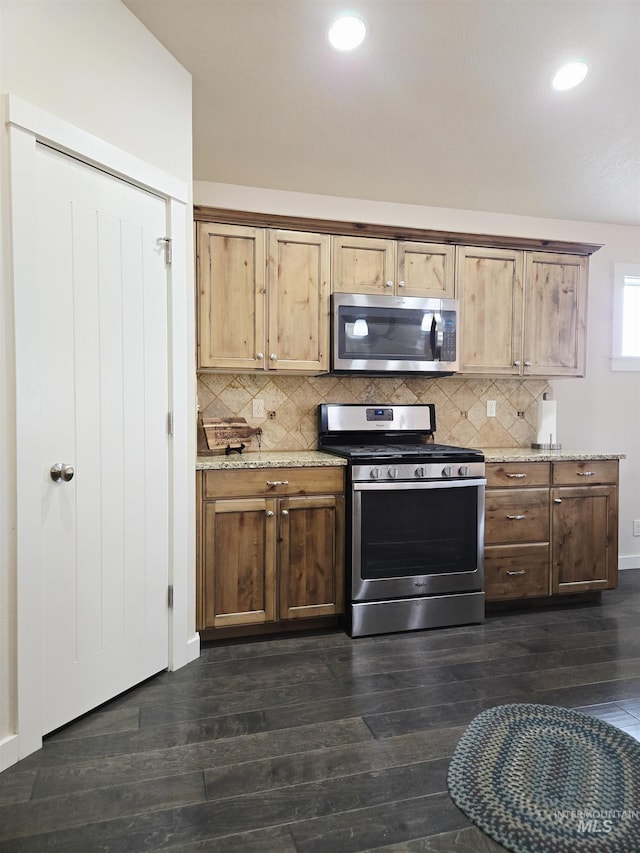 2716 Dogwood Ave, Fruitland, ID 83619 - kitchen featuring stainless steel appliances, dark wood finished floors, decorative backsplash, recessed lighting, and light stone counters