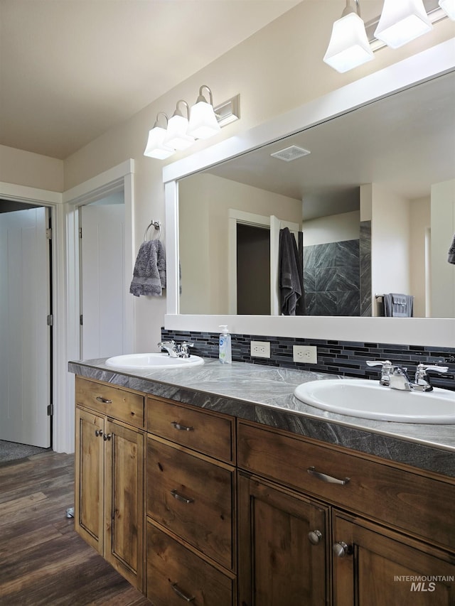 2716 Dogwood Ave, Fruitland, ID 83619 - full bath with double vanity, wood finished floors, and backsplash