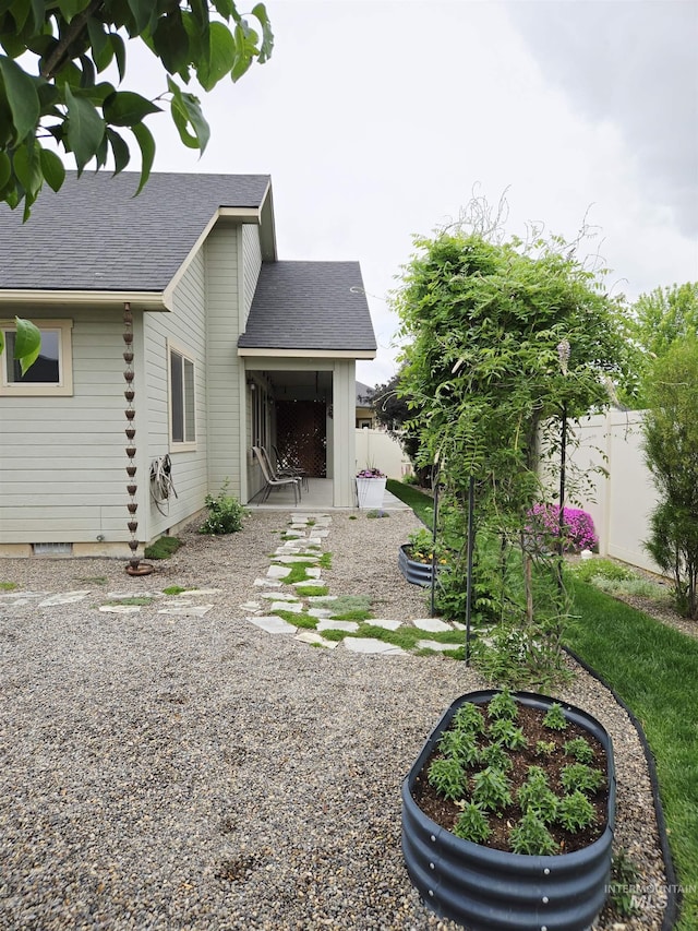 2716 Dogwood Ave, Fruitland, ID 83619 - back of property featuring a shingled roof and a patio area