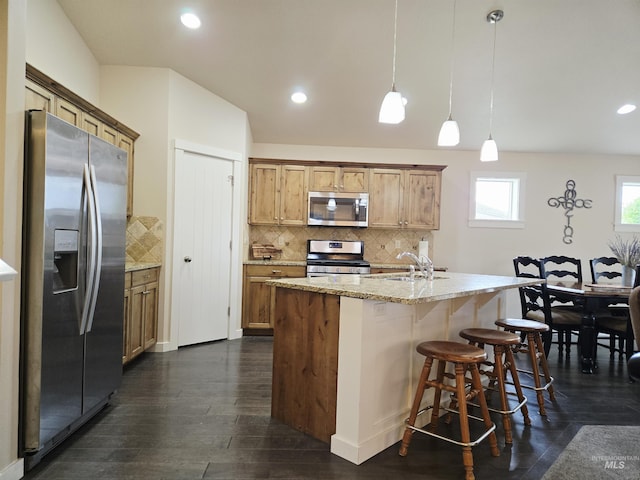 2716 Dogwood Ave, Fruitland, ID 83619 - kitchen with stainless steel appliances, dark wood-style floors, backsplash, a sink, and light stone countertops