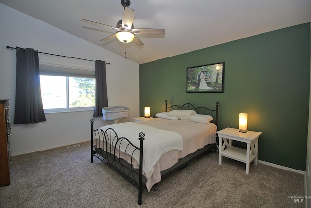 carpeted bedroom featuring baseboards, lofted ceiling, and a ceiling fan