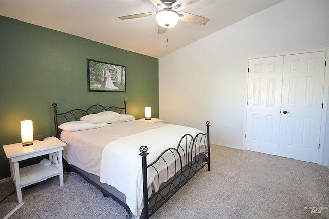 bedroom featuring baseboards, vaulted ceiling, carpet flooring, a closet, and a ceiling fan