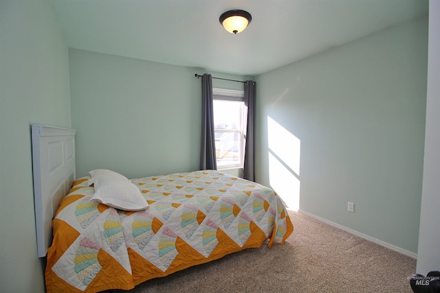 carpeted bedroom featuring baseboards