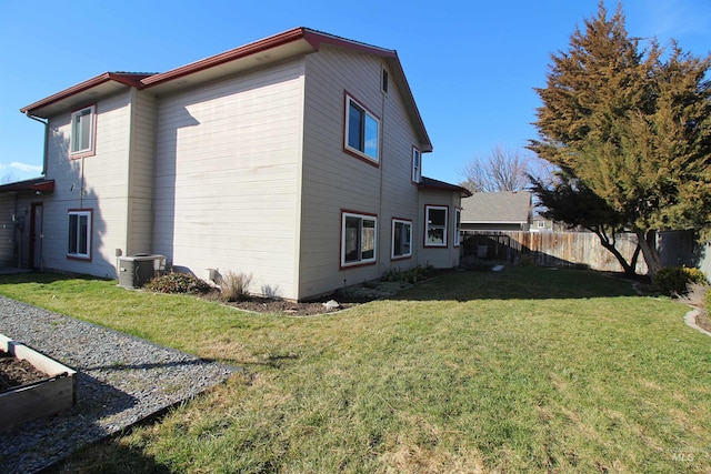 view of home's exterior featuring cooling unit, a yard, and fence